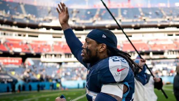 Titans running back Derrick Henry waves to the crowd as he runs off the field.